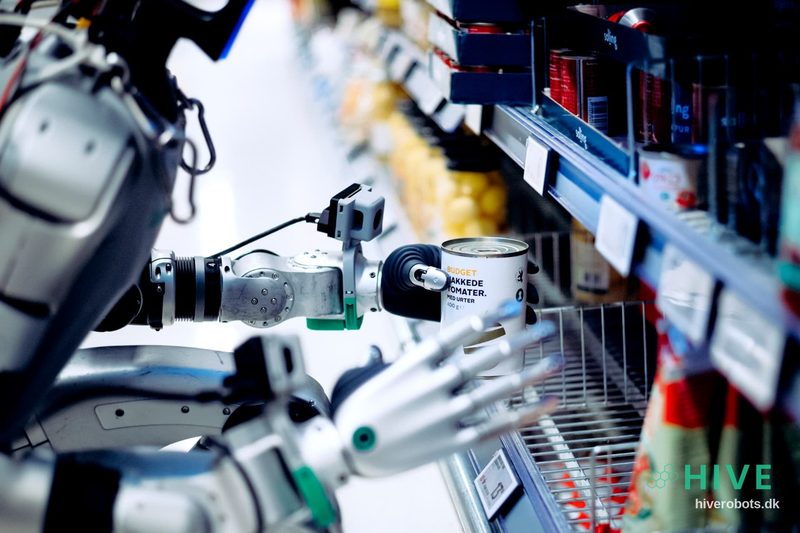 HIVE humanoid robot picking up a can