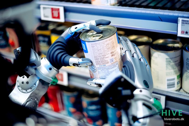 Robot hands facing a tinned tomato can on the shelf